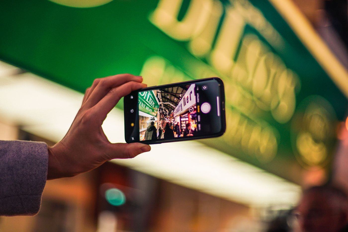 A phone screen lit up on a dark city street at night