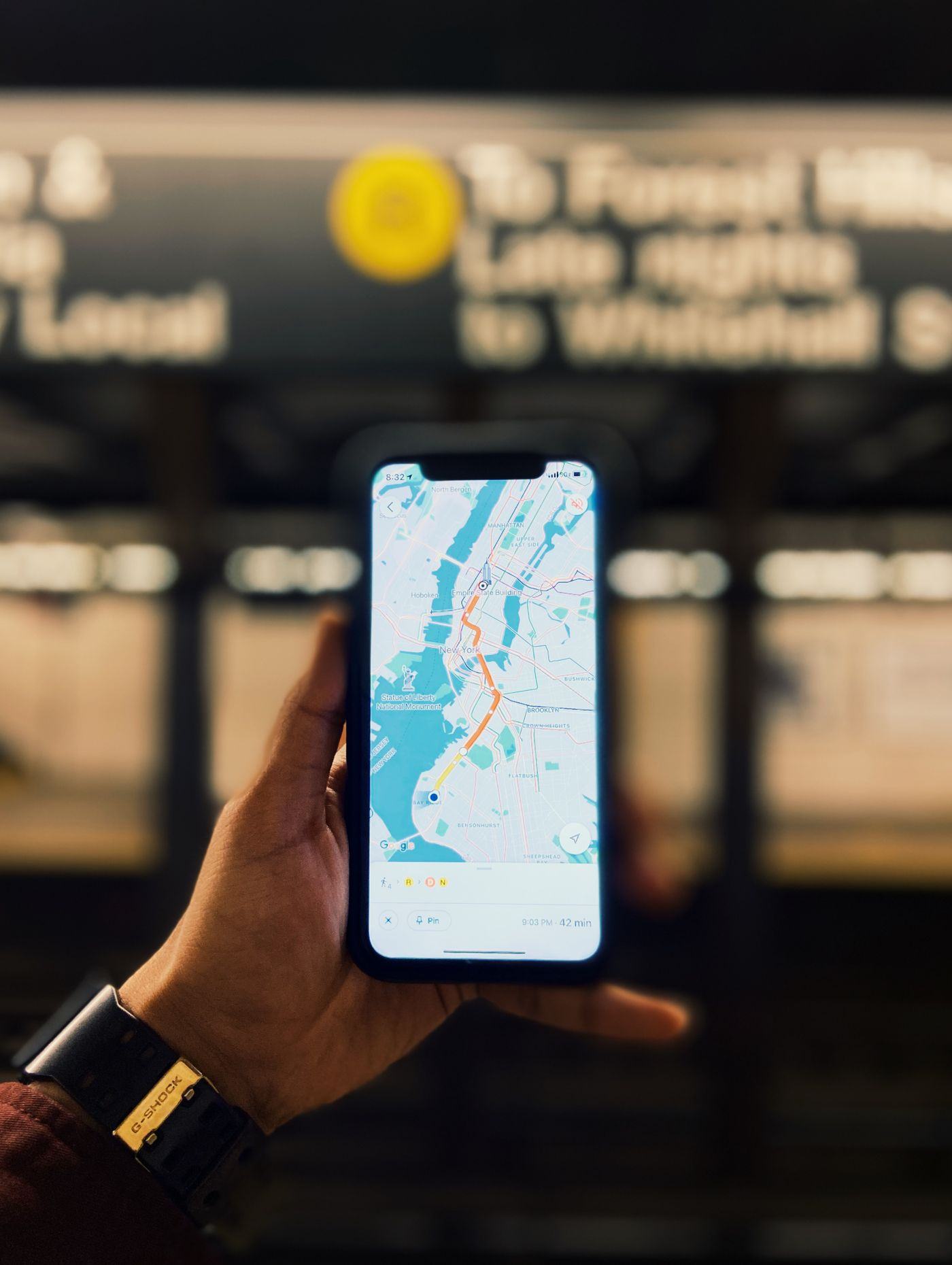 A traveller checking a map on a phone while riding a subway